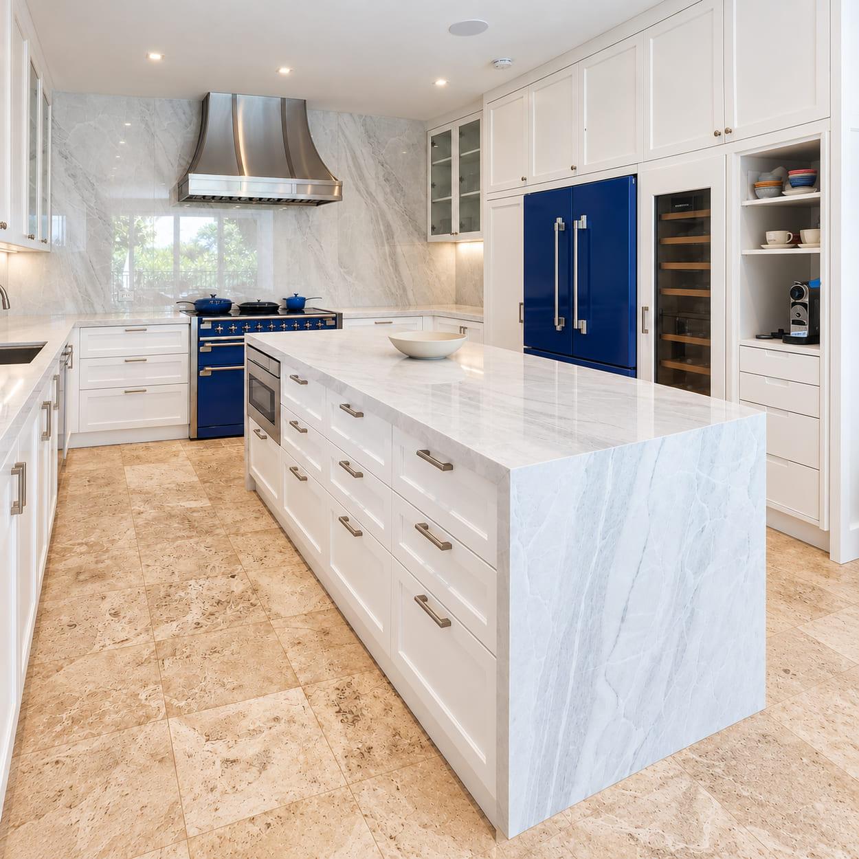 The new island: inset drawer fronts under one marble slab with a mitred waterfall end