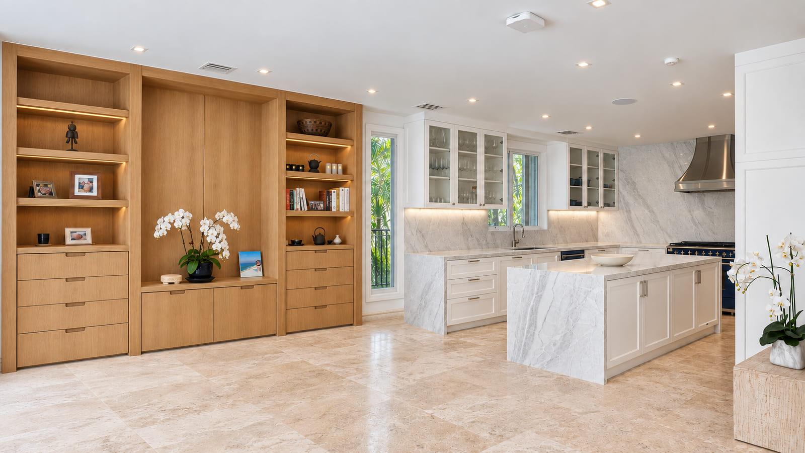 The family room with a white oak library wall and the finished kitchen beyond
