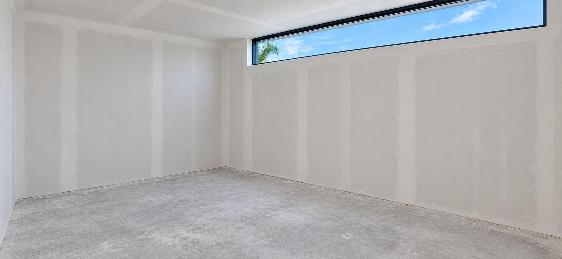 The dressing room as received, seen from the corner, with the clerestory running along the far wall