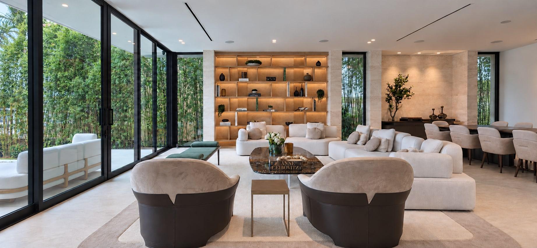 The finished living room: an oak library framed in travertine, a travertine wall beyond it and the same glazing