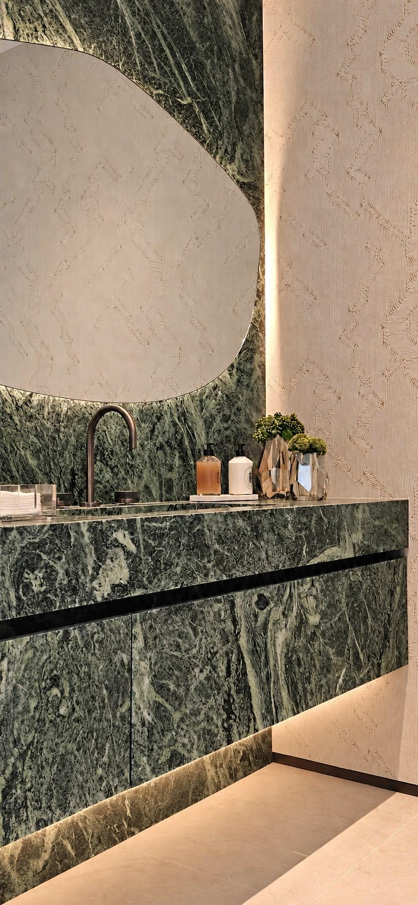 Floating green marble vanity lit from underneath, with the same stone carried up the wall