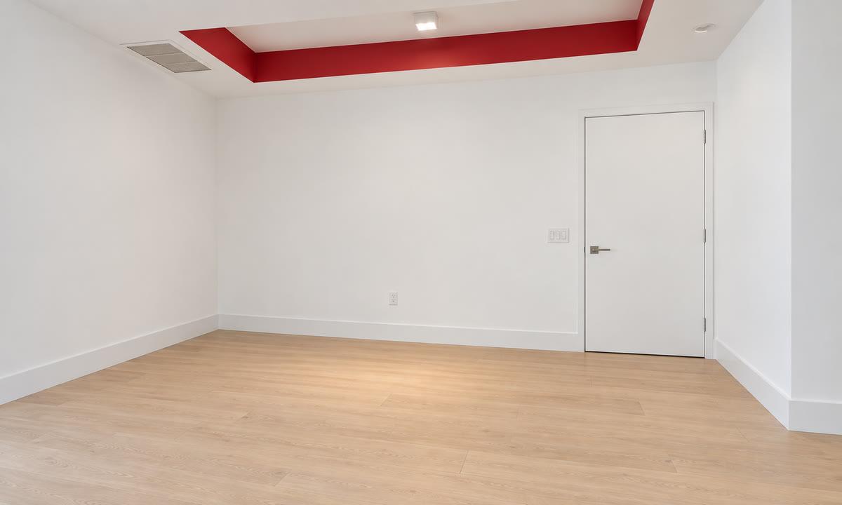 The room as received: white drywall and a red painted ceiling perimeter