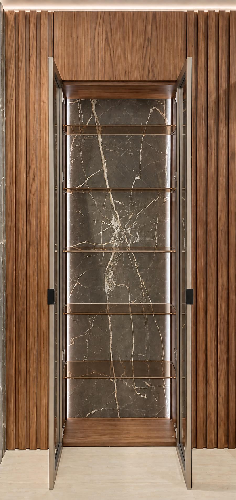 Backlit display cabinet with brass shelves and marble back